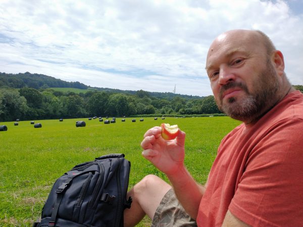 Mike eating lunch in a clover field